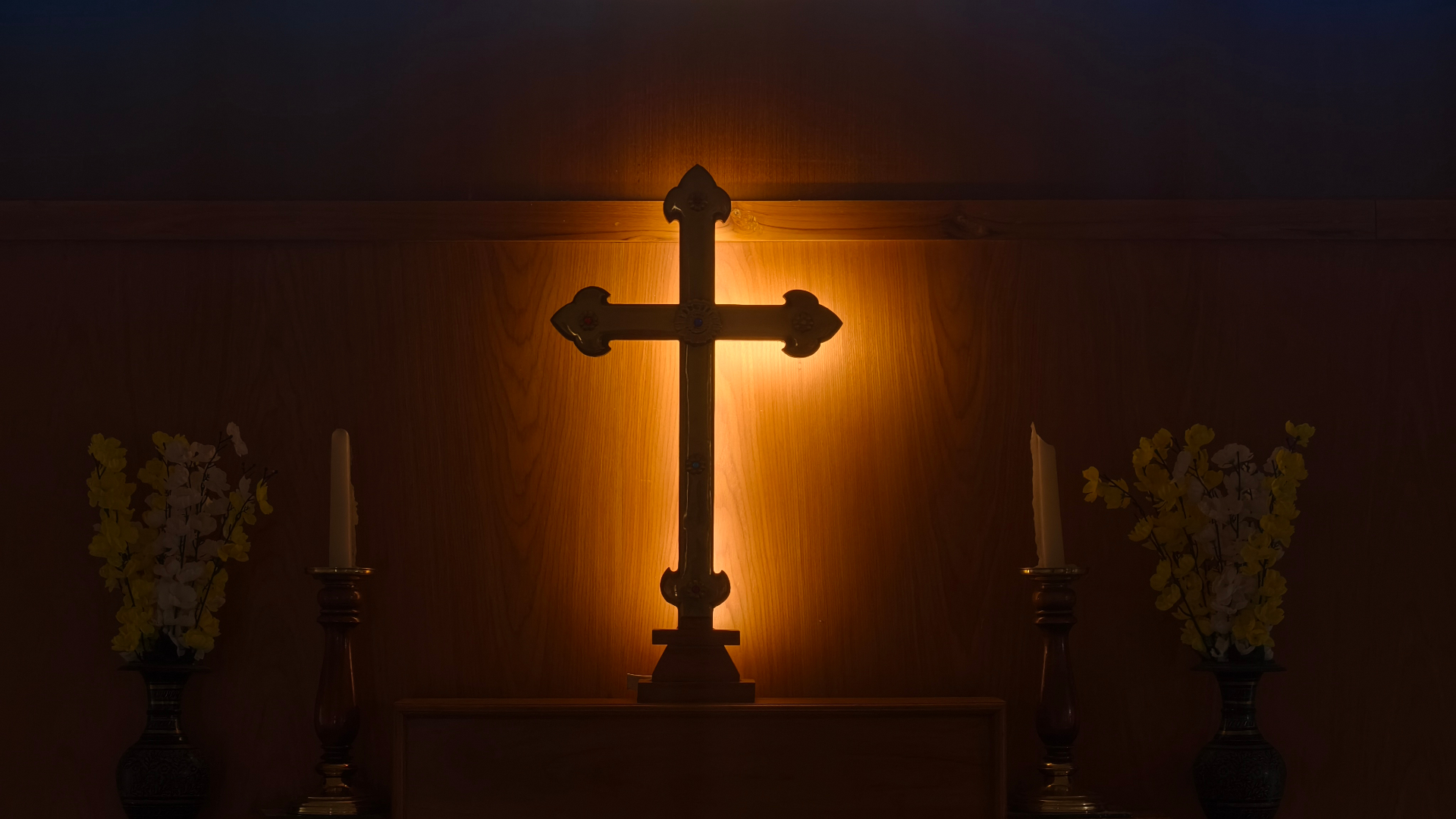 Illuminated cross in the chapel at Krupa Sadanam